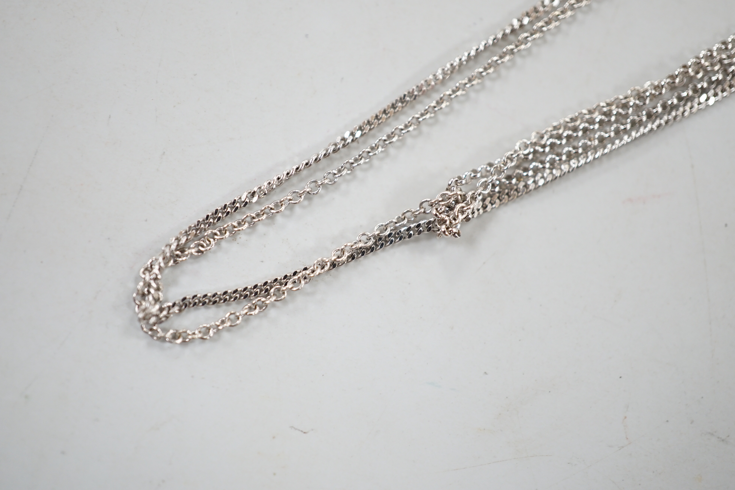 Three assorted modern 18ct white gold fine link chains, longest 42cm, 5.9 grams.